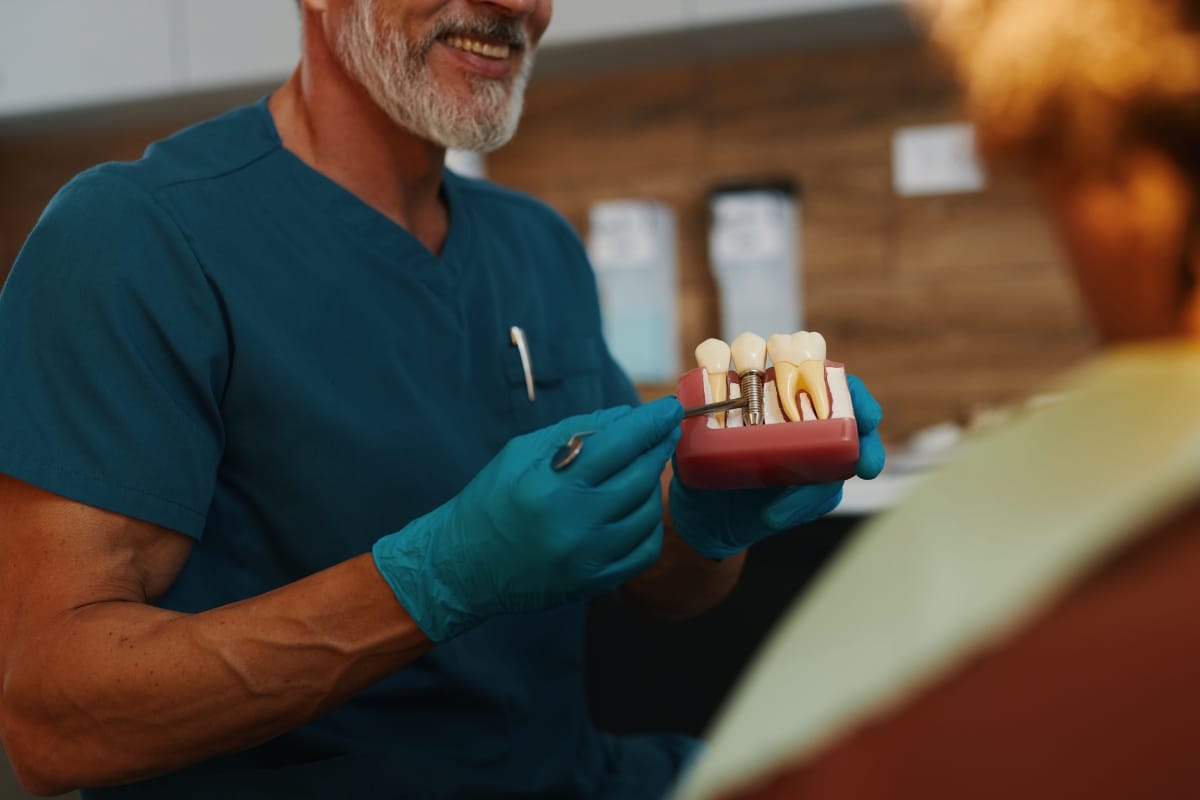 Dentist explaining dental implant procedure to patient in Little Rock clinic